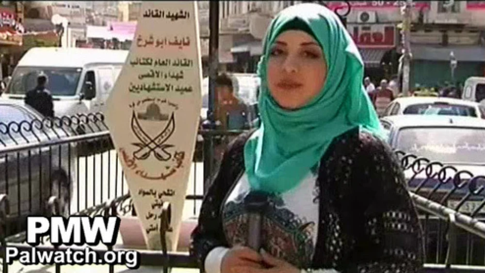 The mother of Palestinian terrorist Naif Abu Sharakh is pictured next to a new monument in a Nablus city square that was renamed after her son. Credit: Palestinian Media Watch.