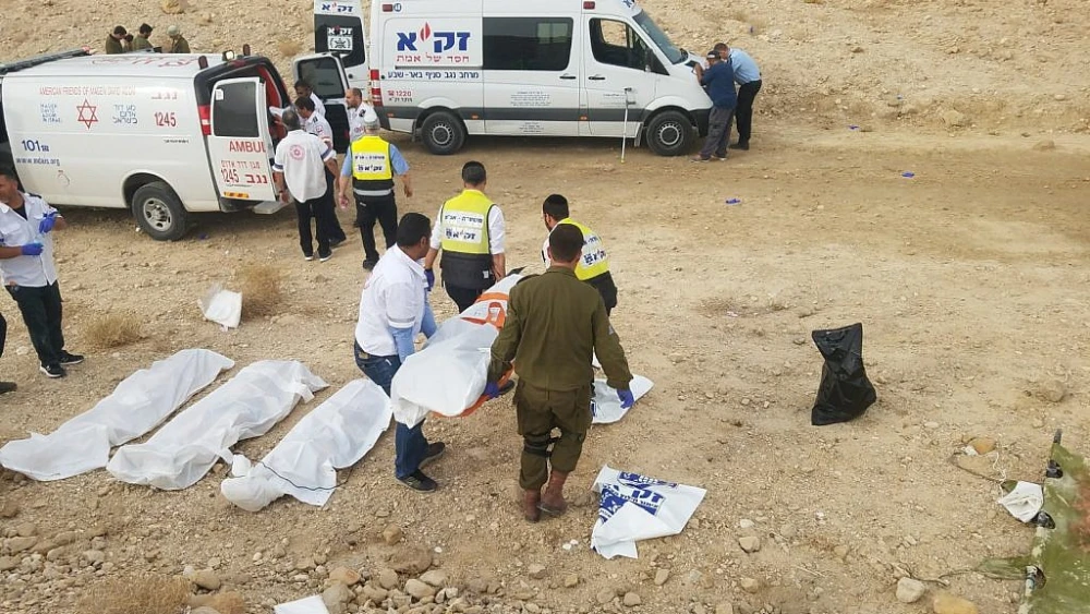 ZAKA emergency volunteers transport the bodies of nine students killed during flash floods while hiking as a group in the Nahal Tzafit riverbed on April 26, 2018. Photo courtesy of ZAKA.