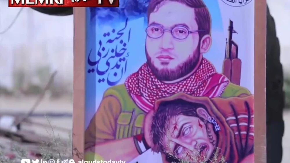 A poster in Gaza showing Hazem Yasser Arhim, an Al-Quds Brigades commander, holding the head of an Israeli soldier. (MEMRI)