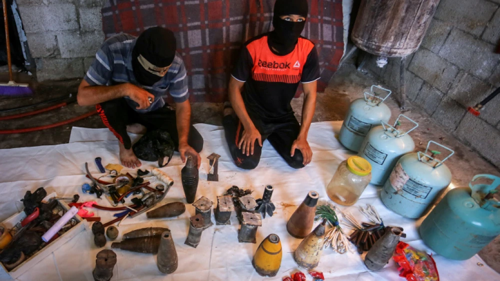 Palestinians prepare explosives and flammable materials to be attached to balloons and launched into Israel from the Gaza Strip, Aug. 8, 2020. Photo by Abed Rahim Khatib/Flash90.