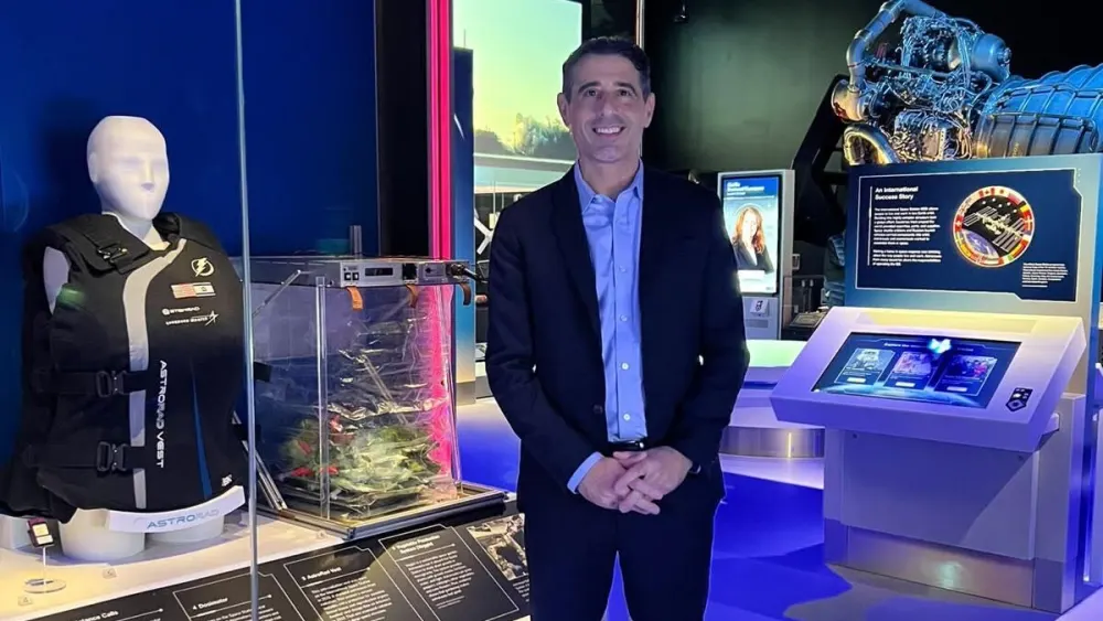 Oren Milstein, CEO and co-founder of StemRad, stands next to the AstroRad vest on display at the Smithsonian’s National Air and Space Museum in Washington, D.C. Credit: Courtesy of Oren Milstein.