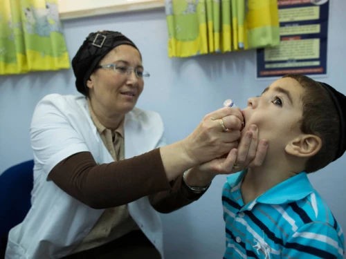 A boy is vaccinated against polio in the Neve Yaakov neighborhood of Jerusalem, Sept. 10, 2013. Photo by Yonatan Sindel/Flash90.