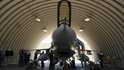 Israeli soldiers prepare an F-16 jet