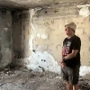 Gadi Moses stands amid the ruins of a house in Kibbutz Nir Oz, Aug. 26, 2025. Photo by Amelie Botbol.