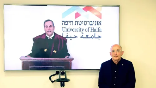 Harvard University president Lawrence Bacow receives an honorary doctorate from University of Haifa president Ron Robin, March 15, 2021. Credit: University of Haifa.