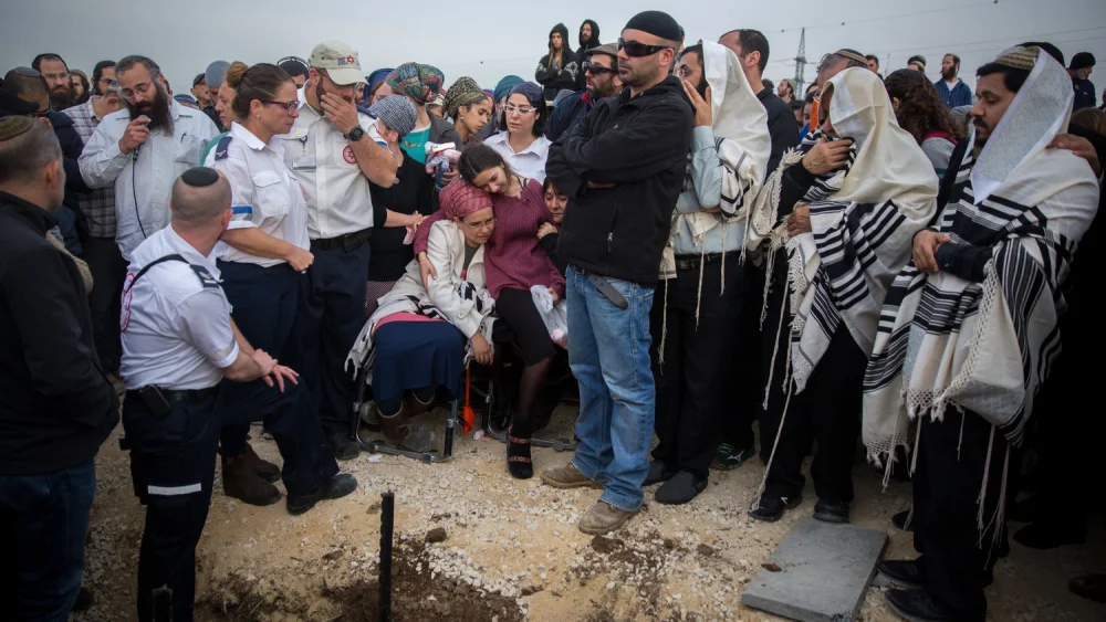 Friends and family attend the funeral of terror victim Rabbi Raziel Shevah, 35, in the Samaria settlement outpost of Havat Gilad on Jan. 10, 2018. Credit: Miriam Alster/Flash90.