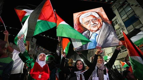 Palestinians in Ramallah wave their national flags and a picture of Palestinian Authority leader Mahmoud Abbas while they watch a live-screening of Abbas's speech at the United Nations, Sept. 30, 2015. Photo by Flash90.