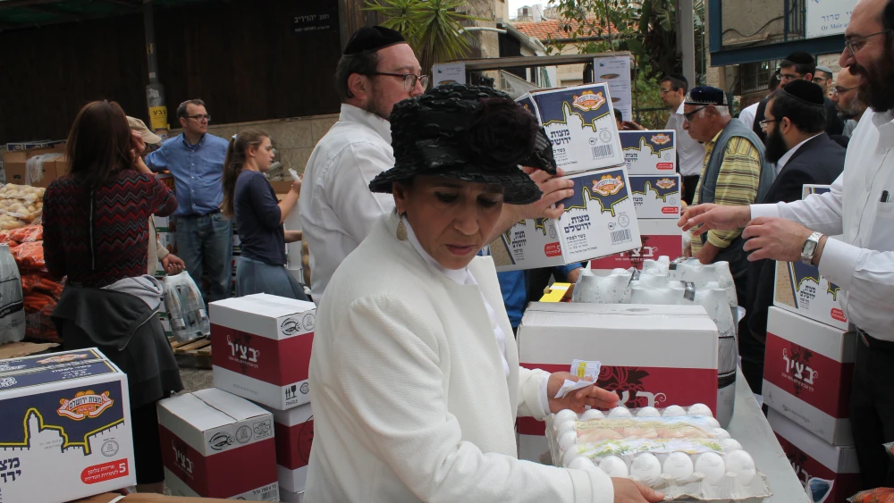 Liora Tedgi, the founder of Ohr Meir & Bracha, handling eggs for Pesach. Credit: Courtesy.