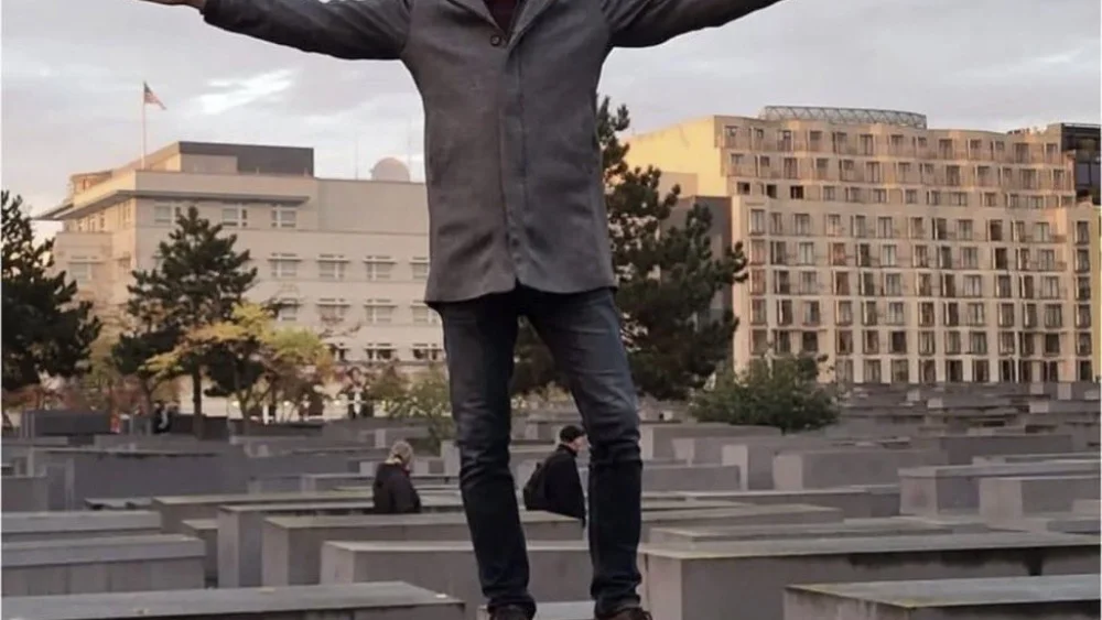 AfD politician Holger Winterstein on one of the 2,711 stone slabs at the Holocaust Memorial in Berlin, Oct. 8, 2022. Source: Twitter.
