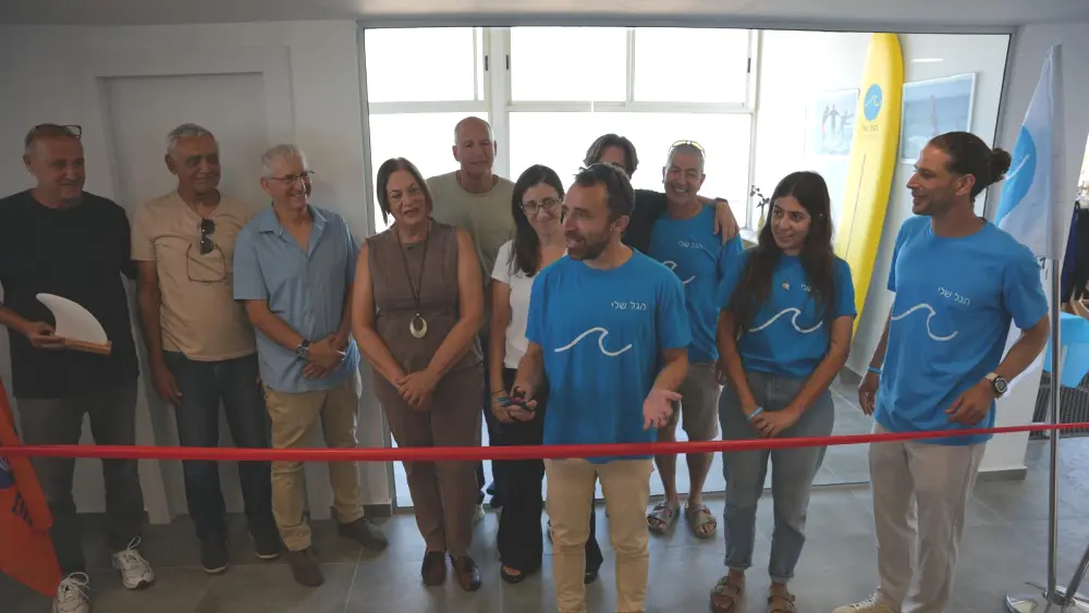Omer Tulchinsky, co-founder and curriculum director of HaGal Sheli, leads the ribbon-cutting ceremony for the organization’s new surf therapy center in Netanya, Israel, which opened on July 8, 2026. Credit: Courtesy of HaGal Sheli.