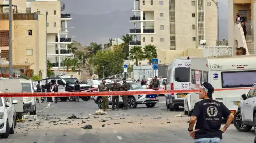 People inspect the damage at the scene where an Iranian missile wounded two civilians and damaged property in Eilat, southern Israel, on March 14, 2026. Photo by Yehuda Ben Itach/Flash90.