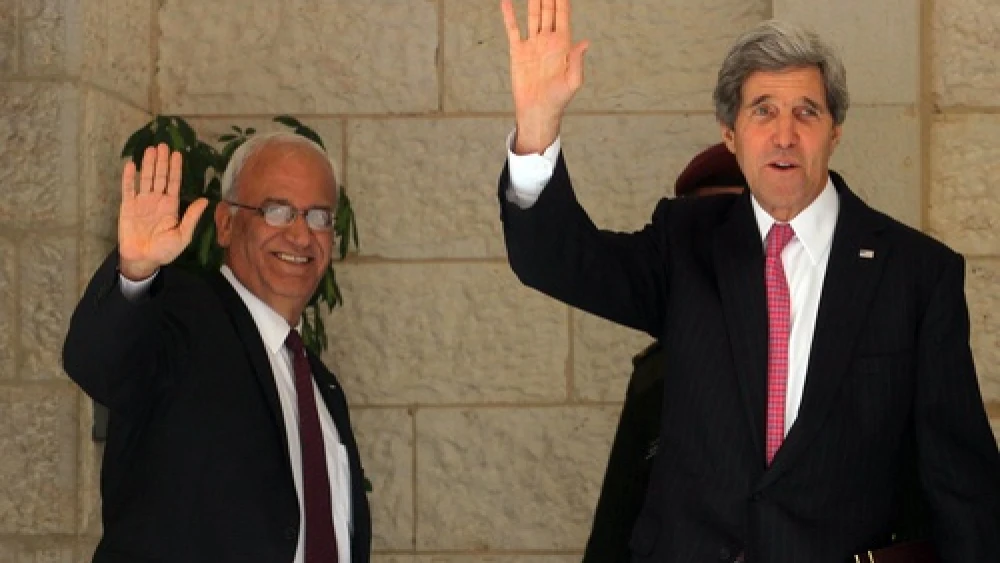 U.S. Secretary of State John Kerry and chief Palestinian negotiator Saeb Erekat wave before a meeting with Palestinian Authority leader Mahmoud Abbas in Ramallah on Jan. 4, 2014. After recent developments, all parties involved may soon be waving goodbye to the Israeli-Palestinian peace negotiations, which have an April 29 deadline for a resolution. Credit: Issam Rimawi/Flash90.
