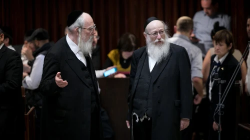United Torah Judaism Knesset members Yaakov Litzman and Yisrael Eichler during a plenum session in the Israeli parliament on March 12, 2018. Photo by Miriam Alster/Flash90.