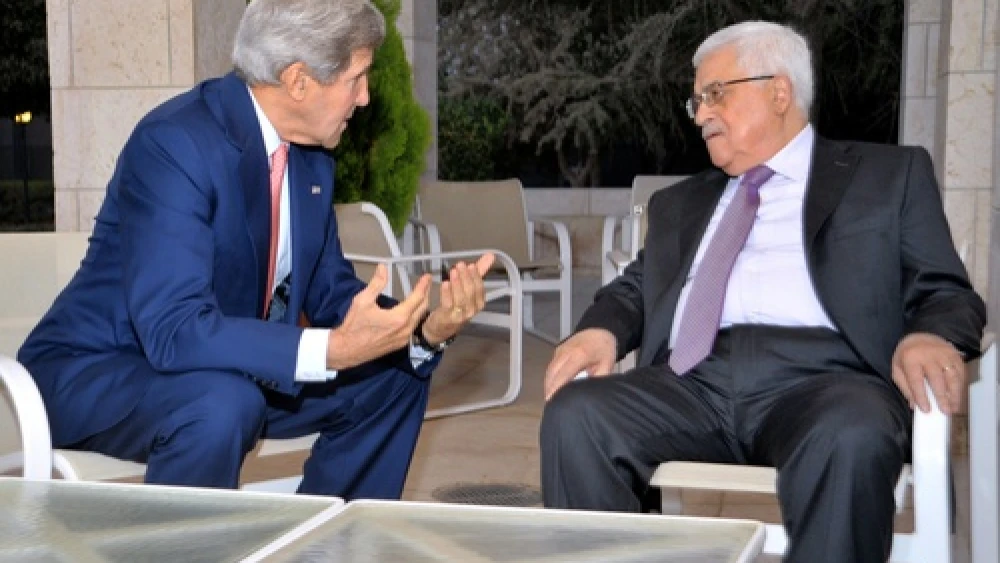 U.S. Secretary of State John Kerry sits with Palestinian Authority leader Mahmoud Abbas before they meet and celebrate Iftar, the breaking of the daily fast during the Islamic holy month of Ramadan, in Amman, on July 16, 2013. Credit: U.S. State Department.