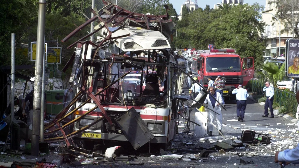 Police and rescue personnel work at the scene of a Palestinian suicide bombing on a bus in Haifa on March 5, 2003. Photo by Ronen Lidor/Flash90.