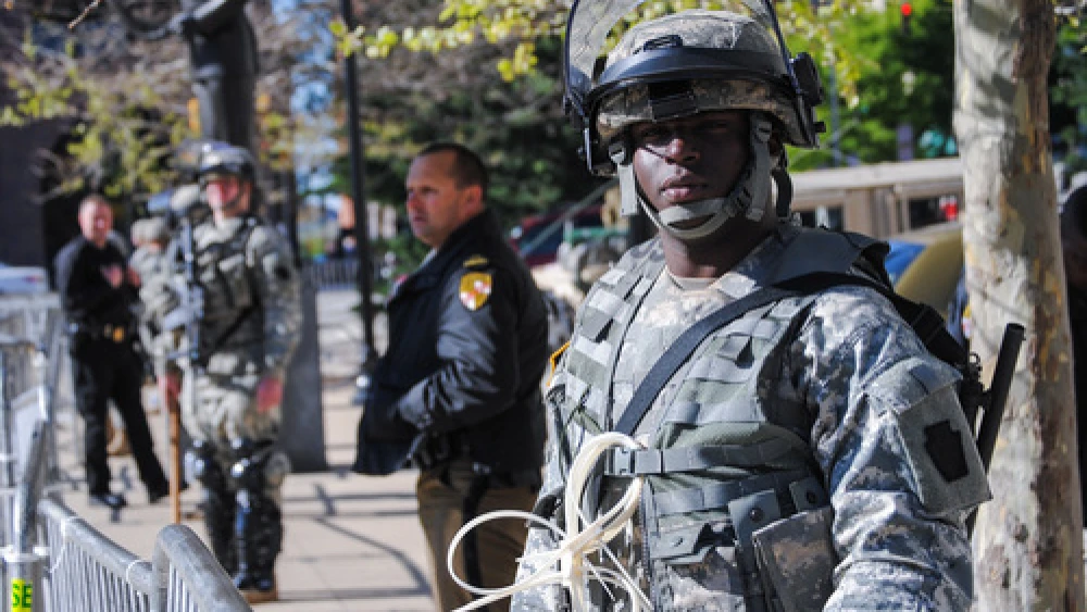 Click photo to download. Caption: A Maryland National Guard soldier keeps watch in front of Baltimore City Hall on April 28 to help deter violence in that area. Credit: Staff Sgt. Ron Lee, 29th Mobile Public Affairs Detachment.