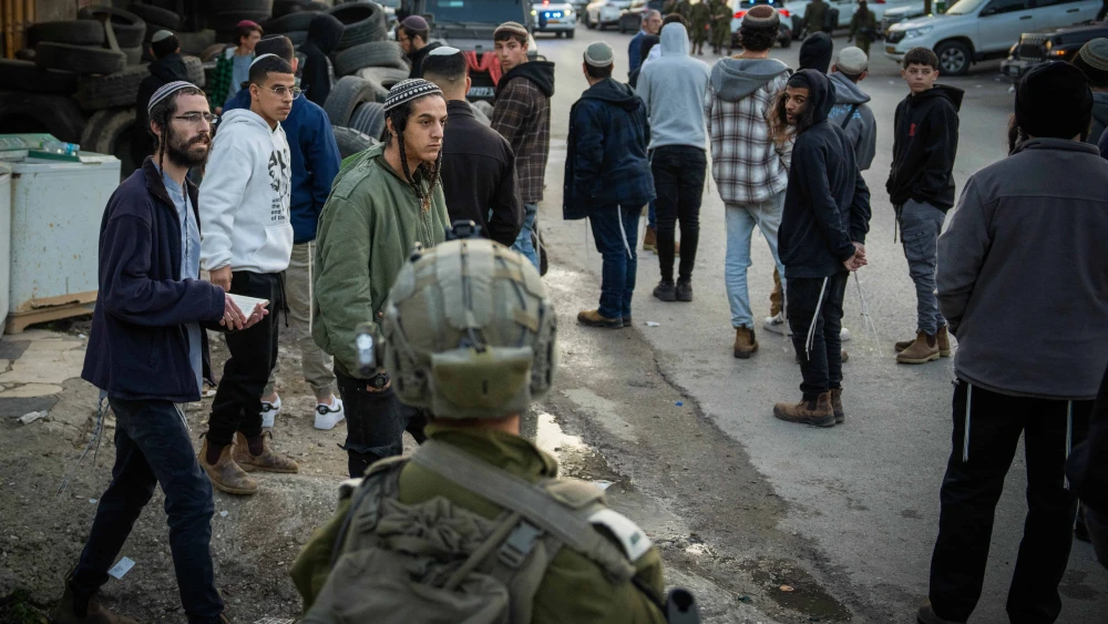 Jews pray at the scene where three Israelis were murdered in a shooting attack, in the village of al-Funduq in Samaria, Jan. 6, 2025. Photo by Erik Marmor/Flash90.