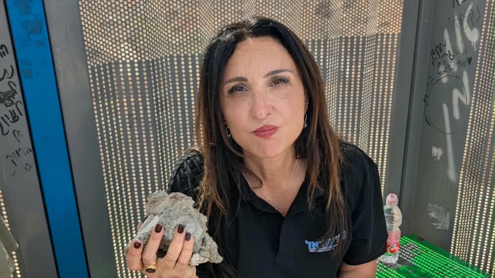 Fleur Hassan-Nahoum holding the rock that smashed their window