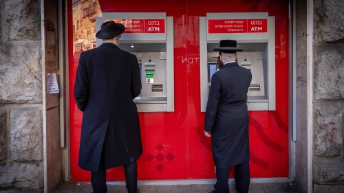 Men at ATM machines in the haredi neighborhood of Mea Shearim in Jerusalem, Feb. 5, 2024. Photo by Chaim Goldberg/Flash90.