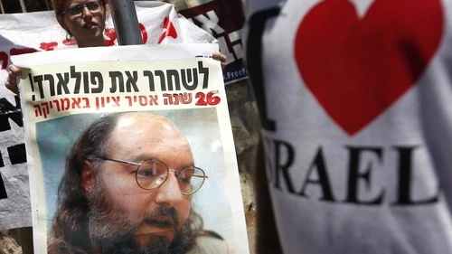 Demonstrators hold signs of Jonathan Pollard as they attend a protest calling for his release outside the house of Israeli President Shimon Peres in Jerusalem, where he met with U.S. congressmen in part to discuss the situation, Aug. 17, 2011. Photo by Miriam Alster/Flash90.