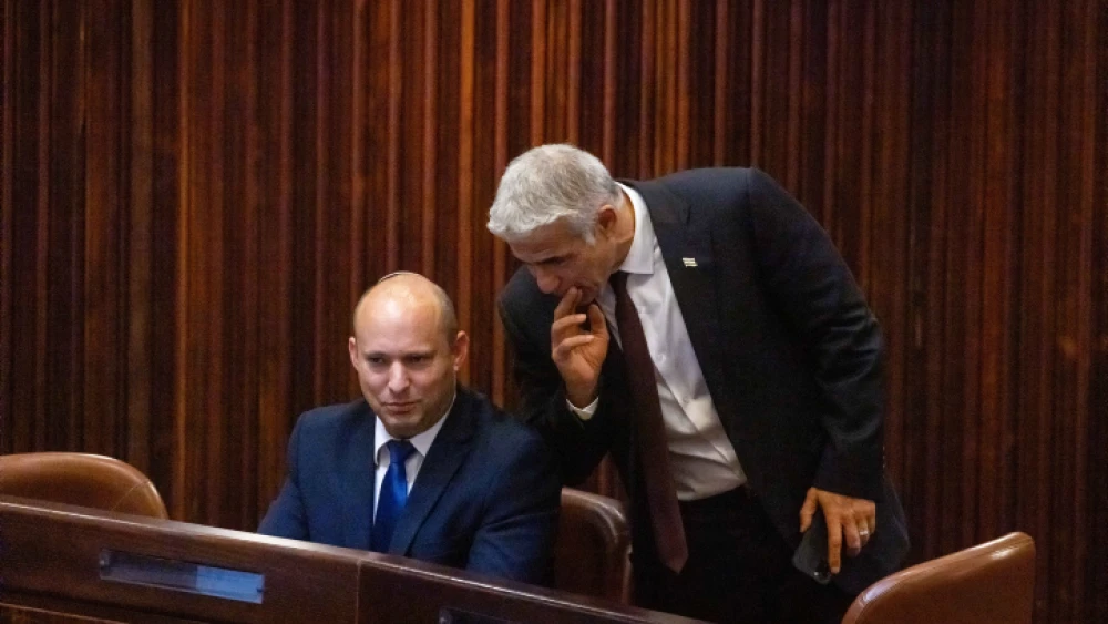 Yamina Party leader Naftali Bennett (seated) and Yesh Atid Party chairman Yair Lapid in the Knesset in Jerusalem during the election for the next Israeli president, June 2, 2021. Photo by Olivier Fitoussi/Flash90.