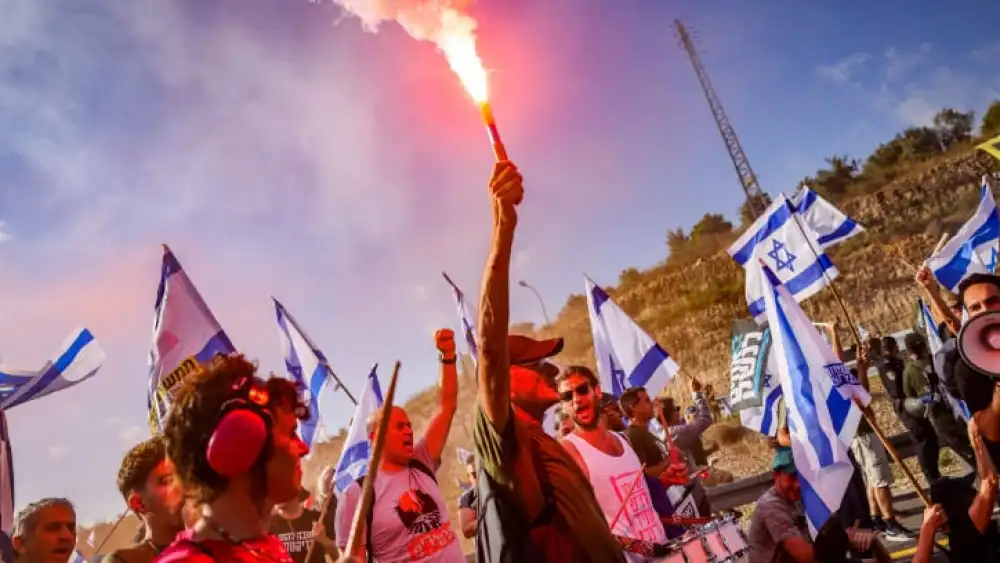 Demonstrators block Route 1, the main highway between Tel Aviv and Jerusalem, and clash with police near Ein Hemed, July 11, 2023. Photo by Chaim Goldberg/Flash90.