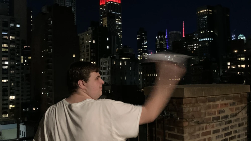 Max Wagenberg launching his paper airplane off his New York City terrace. Credit: Courtesy.