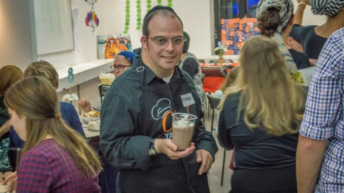Yachad Israel member Rachamim Friedman serves at the cafe. Credit: Yachad.