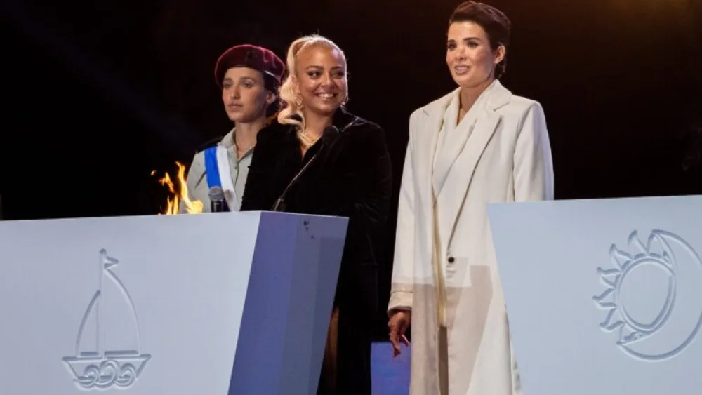 Shira Isakov, right, and her neighbor Adi Guzi lit a torch during the 73rd anniversary Independence Day ceremony on April 14, 2021. Photo by Yonatan Sindel/Flash90.