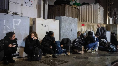 People take cover as siren warns of incoming missile fired from Yemen in Jerusalem, March 20, 2025. Photo by Chaim Goldberg/Flash90.