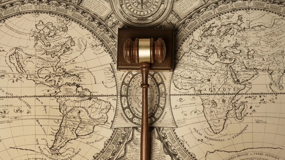 Gavel of justice on old world map