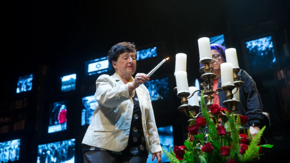 A survivor participates in the annual Holocaust Remembrance ceremony at the Cameri Theater in Tel Aviv, April 7, 2021. Photo by Miriam Alster/Flash90.