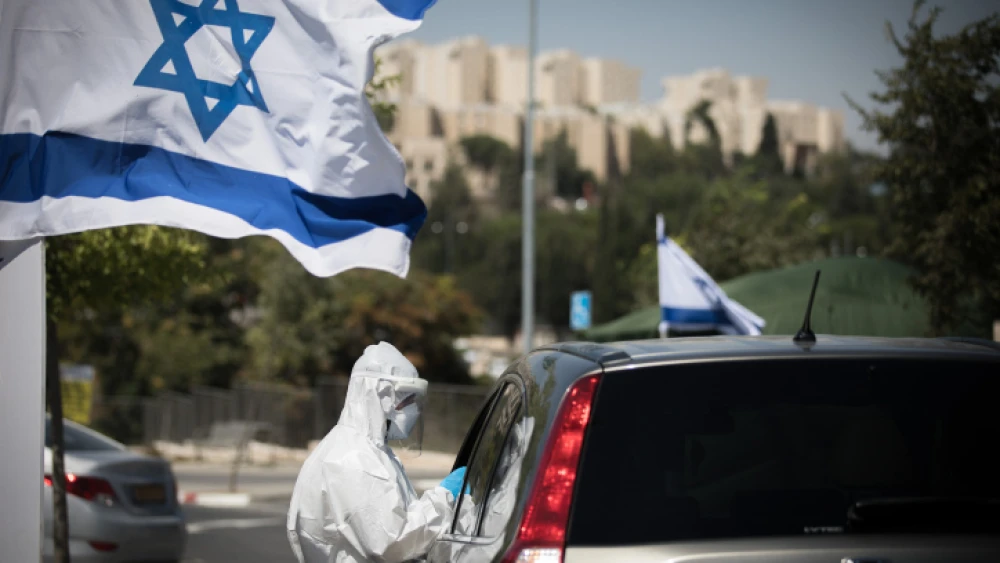 Magen David Adom staff perform drive-through COVID-19 tests on Arab residents of the eastern Jerusalem neighborhood of Sheikh Jarrah, on Aug.17, 2020. Photo by Yonatan Sindel/Flash90.