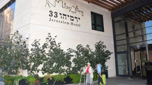A guest displaced from the war with Hamas in the Gaza Strip walks outside Yad Sarah's “Yirmiyahu 33” Rehabilitation and Wellness Hotel in Jerusalem, October 2023. Credit: Courtesy.