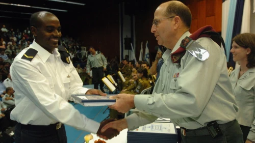 Click photo to download. Caption: Moshe Ya'alon, now Israel's vice prime minister and former IDF chief of staff, presents an award of excellence to an Israeli naval officer. Credit: IDF Spokesperon.