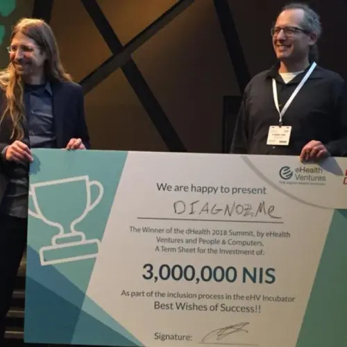 Diagnoz.me founders Ariel Livne and Tamir Epstein accepting their NIS 3 million (nearly $830,000) prize money at the dHealth 2018 Summit. Credit: Courtesy of Israel21c.