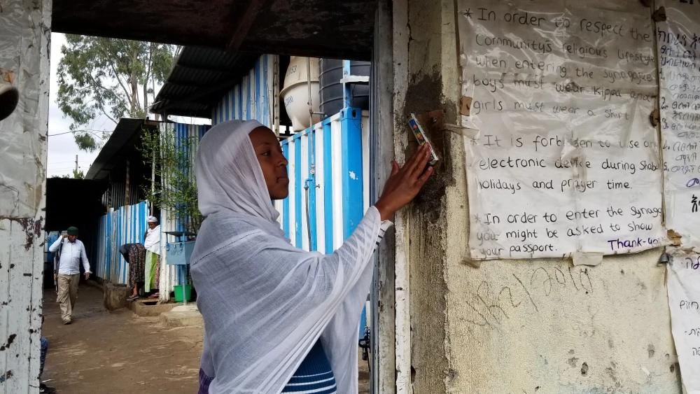 Touching the mezuzah. Credit: The Heart of Israel.