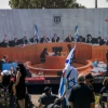 Israelis watch a Supreme Court session on petitions filed against the proposed unity government, outside the Knesset in Jerusalem, on April 3, 2020. Photo by Yonatan Sindel/Flash90.