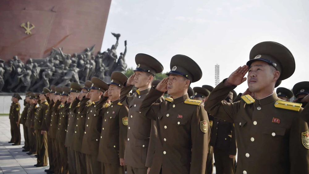 Service personnel of the Ministry of Public Security pay tribute as they visit the statues of late North Korean leaders Kim Il Sung and Kim Jong Il at Mansu Hill in Pyongyang on the occasion of the 76th founding anniversary of North Korea, on Sept. 9, 2024. Photo by Kim Won Jin/AFP via Getty Images.