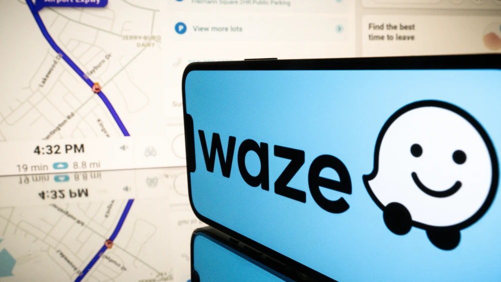 This photograph shows screens displaying the logo and the application Waze, a free navigation application in Toulouse, southern France, on Jan. 15, 2025. Photo by Lionel Bonaventure/AFP via Getty Images.