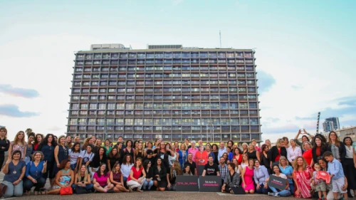 Israeli women working in high-tech pose with a life-size picture of German Chancellor Angela Merkel during a protest a Rabin Square in Tel Aviv on Oct. 10, 2018. Photo by Flash90.