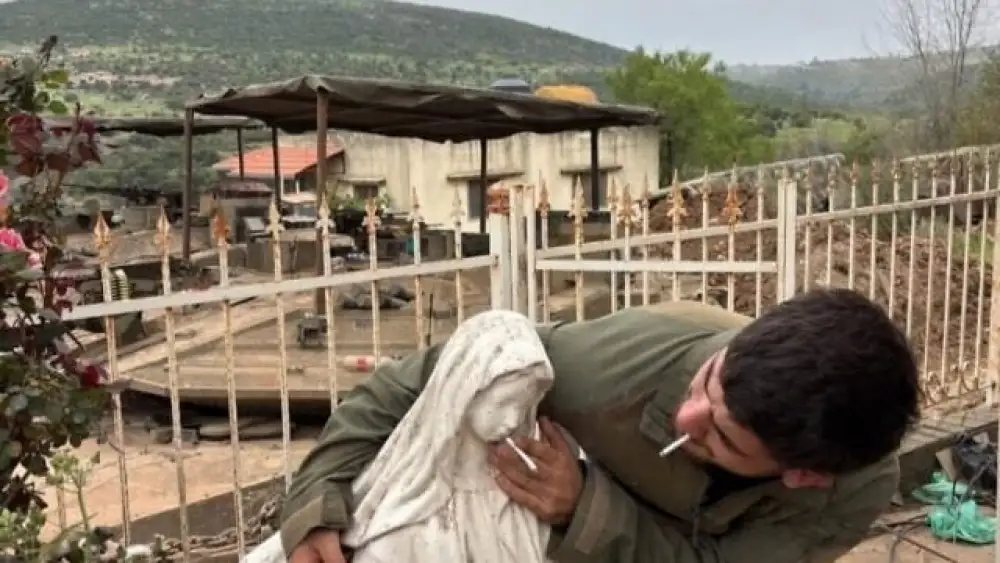 An Israelli soldier places a cigarette into the mouth of a Virgin Mary statue in Debel, southern Lebanon, in a photo circulated online on May 6, 2026. Credit: social media