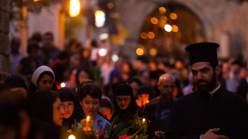 Click photo to download. Caption: Eastern Orthodox Christian nuns hold candles and flowers as they walk along the Via Dolorosa in the Old City of Jerusalem on Aug. 25, 2015. Credit: Micah Bond/Flash90.
