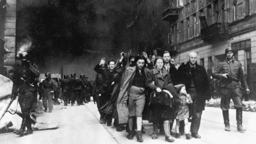 Captured Jews who participated in the Warsaw Ghetto Uprising are rounded up by the Waffen SS on Nowolipie Street between April 19 and May 16, 1943. Credit: Wikimedia Commons.