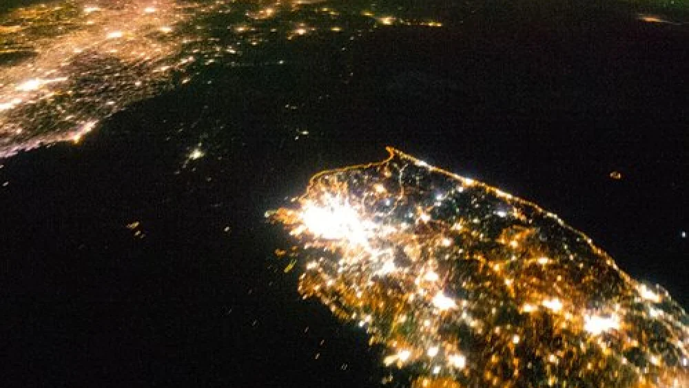 Satellite images like this one illustrate the nature of the North Korean regime, writes columnist Ben Cohen. While South Korea (bottom) sparkles brightly, North Korea (center) is shrouded in pitch black darkness—save for a small glimmer around Pyongyang, the capital, where the officials of the ruling party are quartered, and which is spared, relatively speaking, from the famine and electricity shortages that prevail in the rest of the country. Credit: NASA.