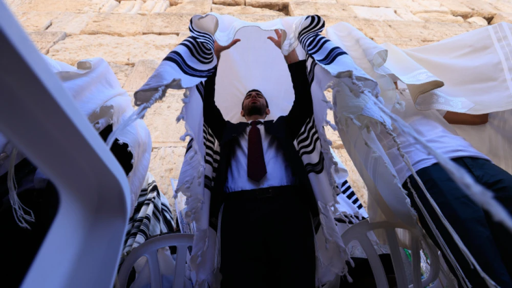 Jewish priests, or kohanim, perform the Priestly Blessing at the Western Wall in Jerusalem's Old City during morning prayers on the second day of Sukkot, Sept. 22, 2021. Photo by Olivier Fitoussil/Flash90.