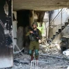An IDF soldier at Kibbutz Be'eri, where Hamas terrorists killed 112 people, Oct. 13, 2023. Photo by Yossi Zeliger/TPS.