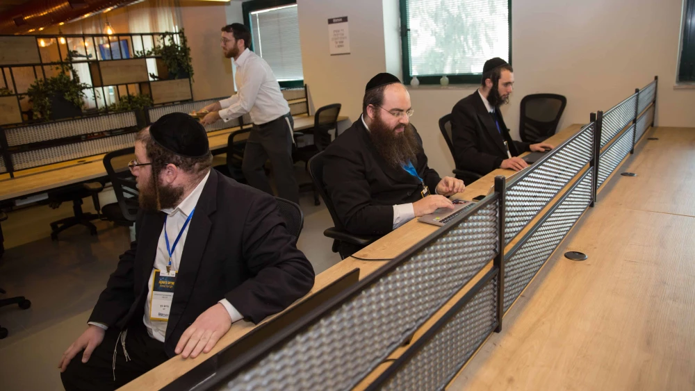 Ultra-Orthodox men work at the Bizmax Innovative Business Complex in Jerusalem, which endeavors to integrate Haredi men into various careers, Feb. 23, 2017. Credit: Flash90.
