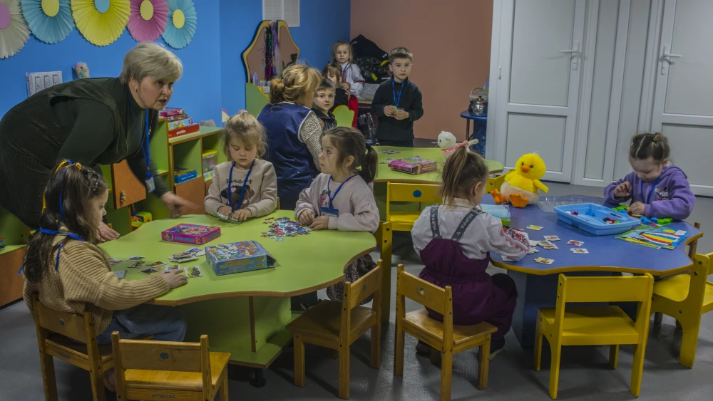 Children are taken care of in a bomb shelter underneath a kindergarten during an air raid siren alert, on March 4, 2026 in Kryvyi Rih, Ukraine. Photo by Martyn Aim/Getty Images.