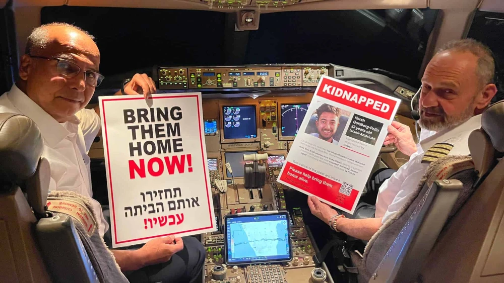 Pilots hold posters of Hamas captive Hersh Goldberg-Polin on the flight he would have taken on a planned trip to Southeast Asia. Credit: Courtesy of Matt Krieger.